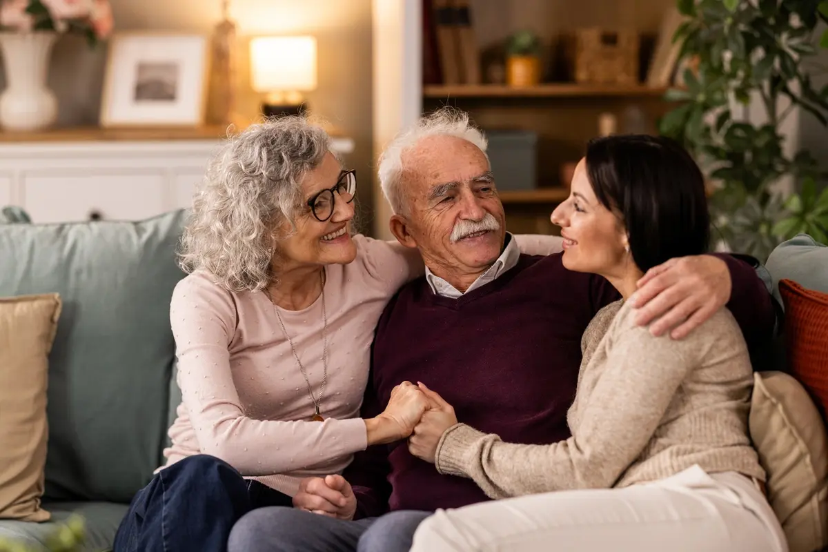 Adult daughter spending time with her senior parents at home while discussing assisted living in Bakersfield, CA.