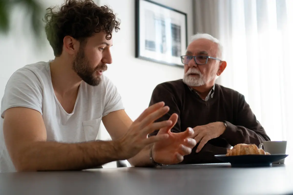 Adult child having a serious conversation with an elderly parent refuses help