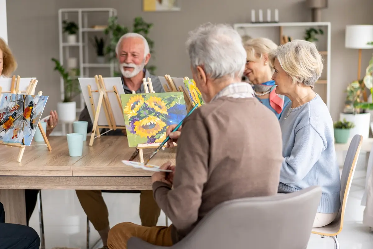Memory care vs assisted living residents enjoying a creative painting activity